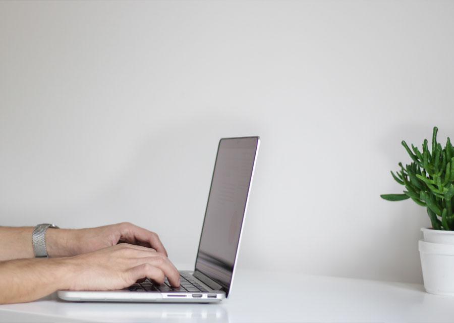 Profesional trabajando en una laptop en un escritorio luminoso